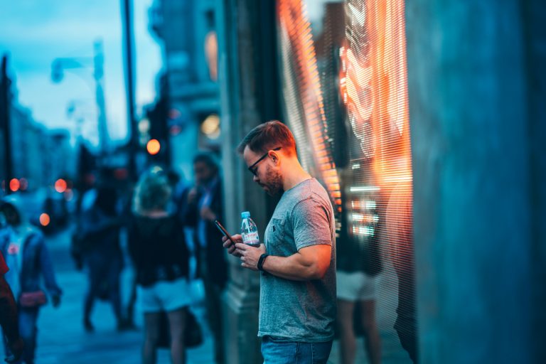 Man using a smartphone on the street.