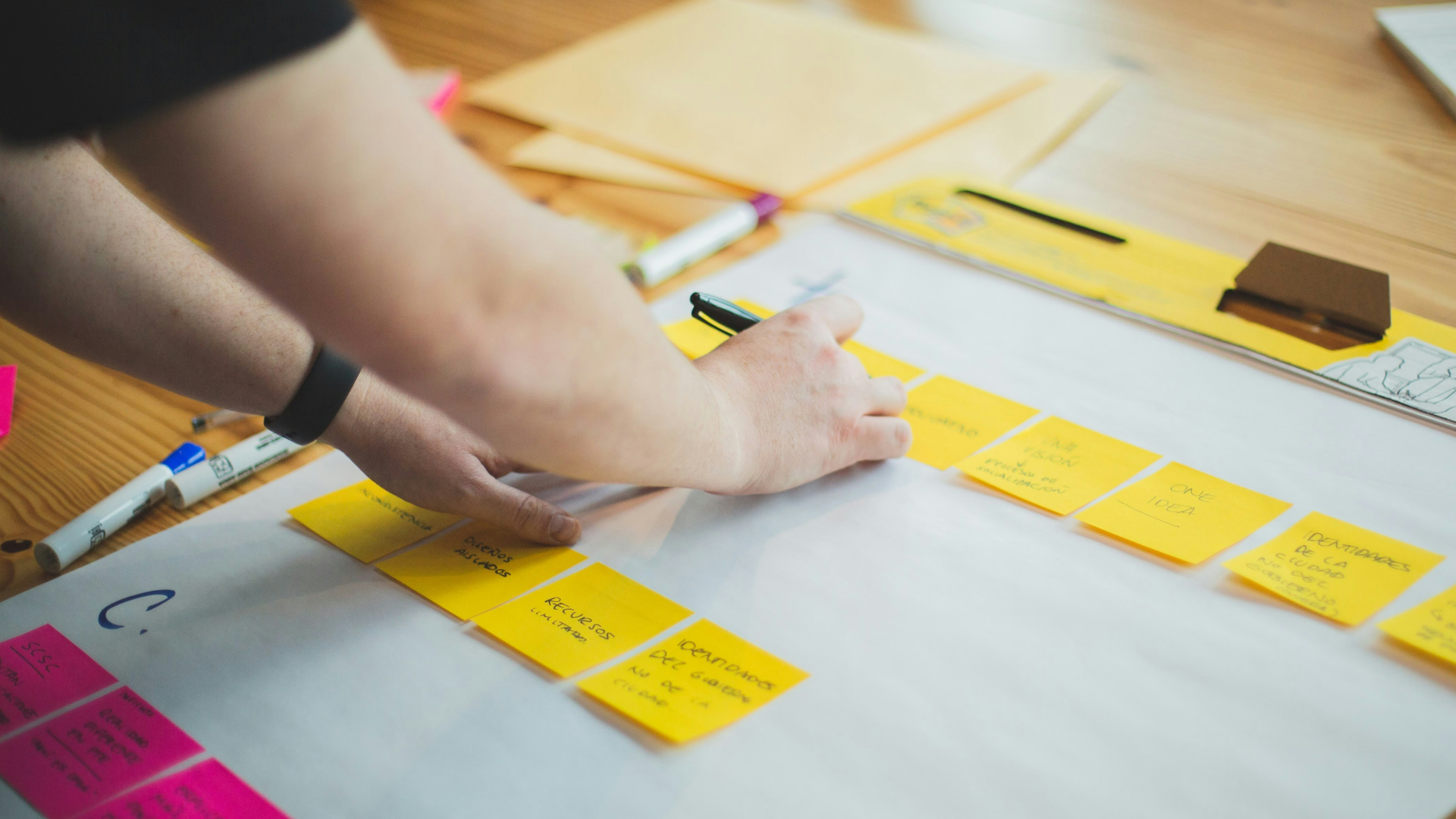 person-writing-post-its-during-service-design-workshop